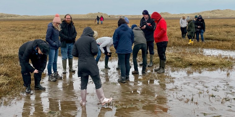 Group of people stood in salt marshes